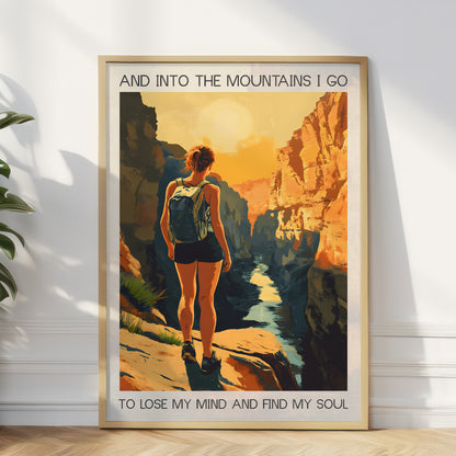 Framed poster of a person hiking with mountains and text on a white wall.