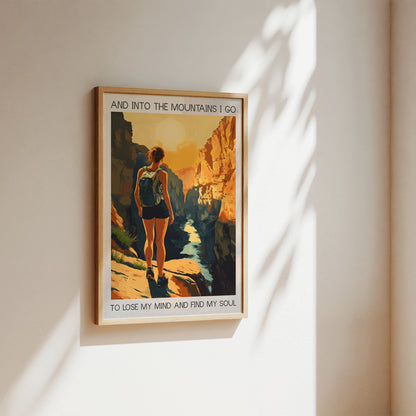 Framed poster of a person hiking with a scenic quote on a wall.