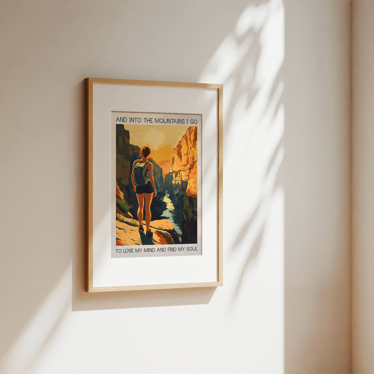 Framed artwork of a person hiking with text on a wall