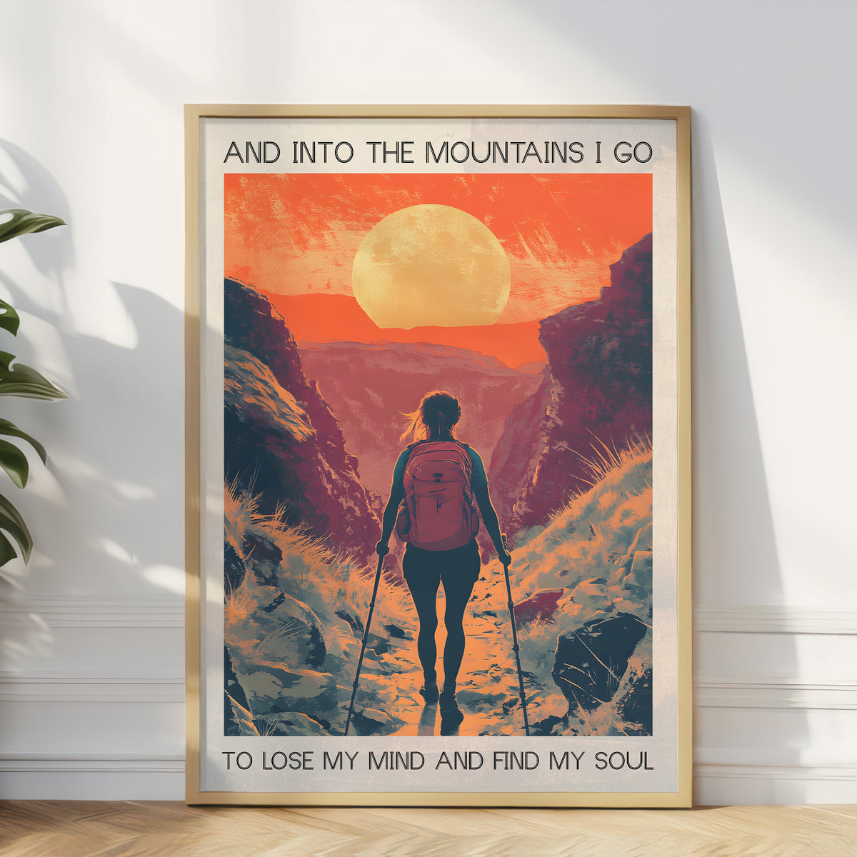 Framed poster of a person hiking with a quote on a mountain path.