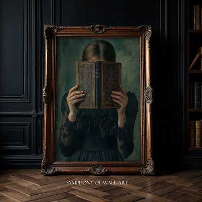 Framed artwork of a woman holding an old book in front of her face against a dark wall.