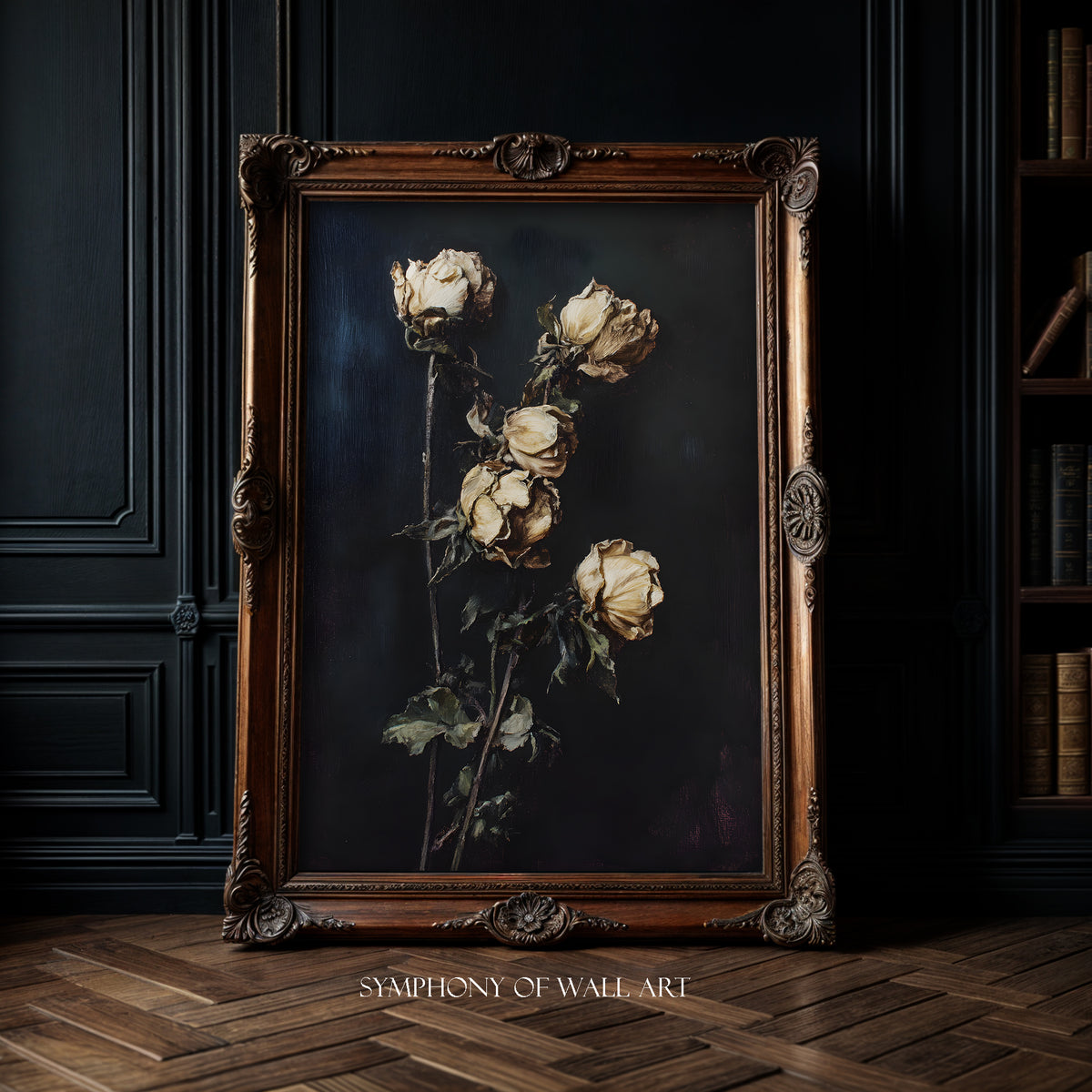 Framed artwork of dried roses on a dark background, displayed in a room with wooden floor and bookshelf.