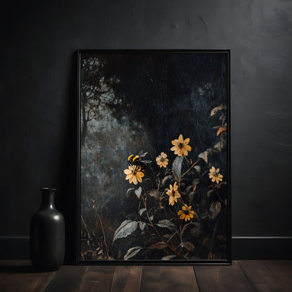 Framed artwork of yellow flowers and a bee on a dark background, placed on a wooden surface with a black vase.