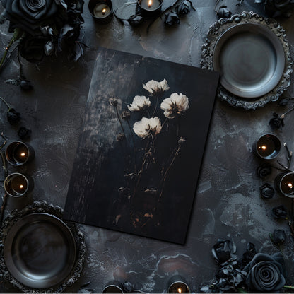 Dark table setting with a floral arrangement on a black card, surrounded by candles and decorative elements.