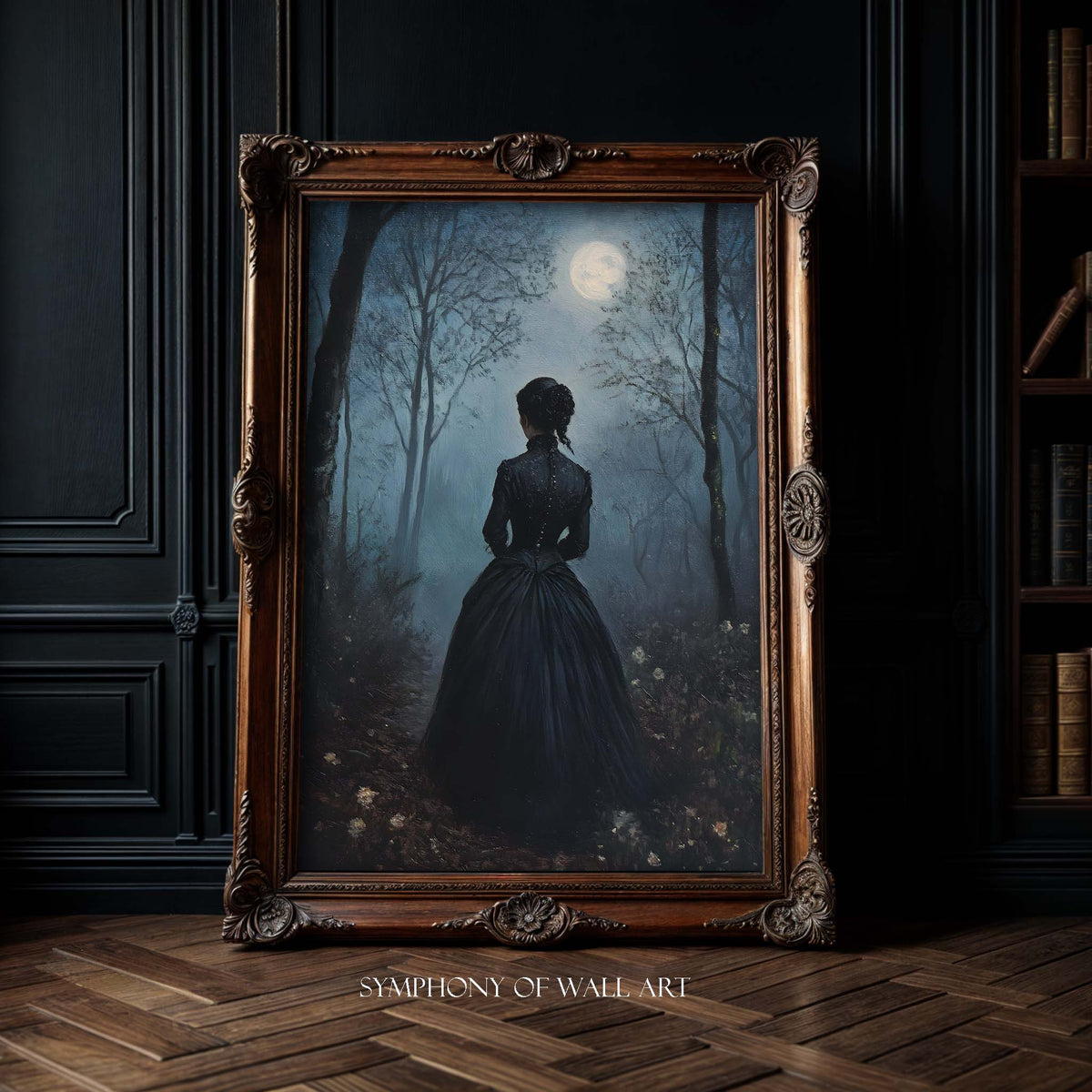 Framed artwork of a woman in a dark dress standing in a forest with a full moon, displayed on a dark wall.