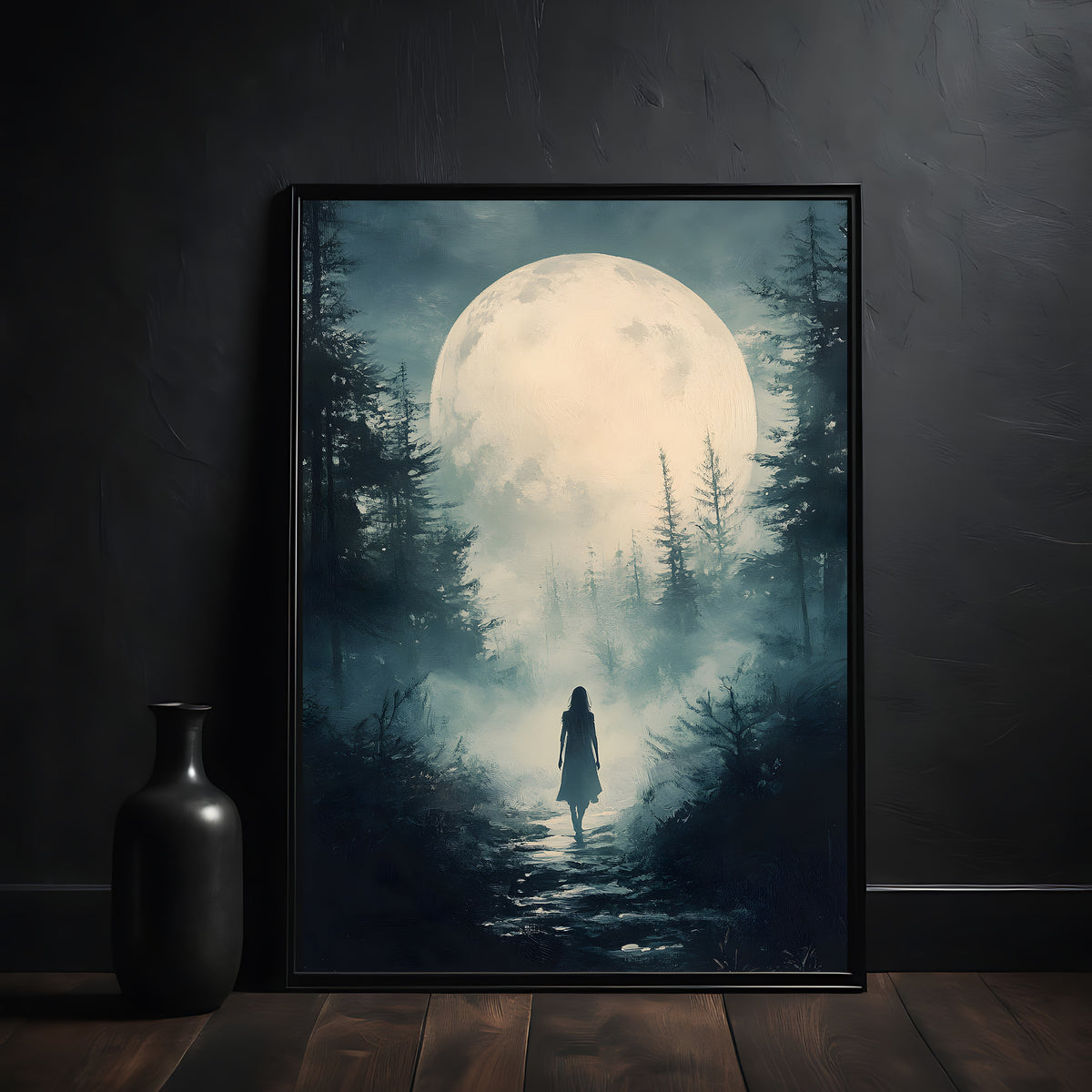 Framed artwork of a person walking through a forest under a large moonlit sky, on a dark wall.
