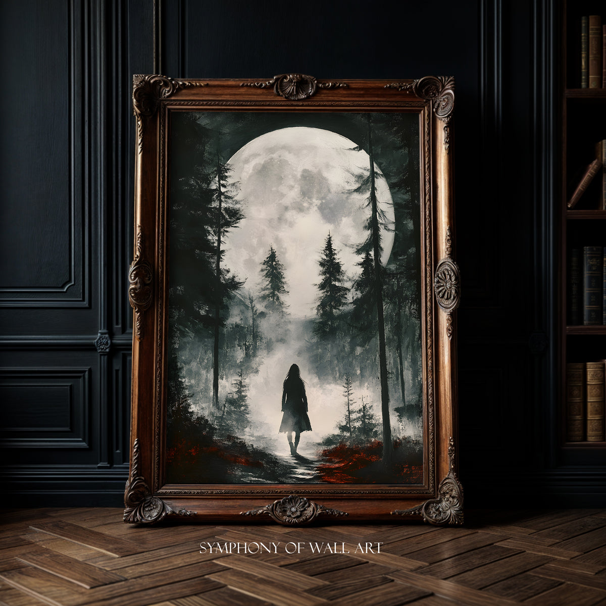 Framed artwork of a person walking through a forest with a full moon, displayed in a room with dark walls and wooden floor.