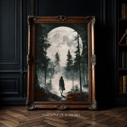 Framed artwork of a person walking through a forest with a full moon, displayed in a room with dark walls and wooden floor.