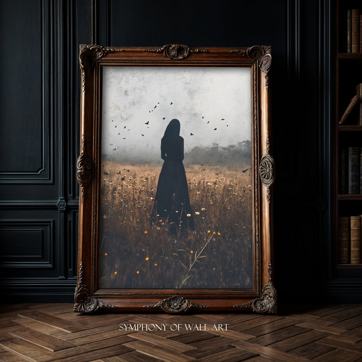 Framed artwork of a silhouette of woman in the black in a autumn field with birds, displayed on a dark wall.