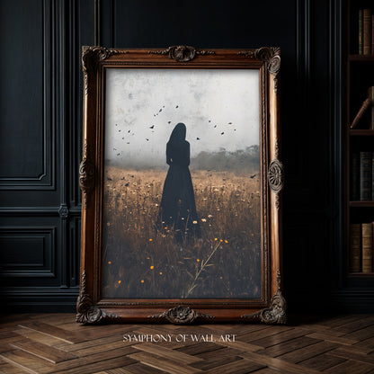 Framed artwork of a silhouette of woman in the black in a autumn field with birds, displayed on a dark wall.